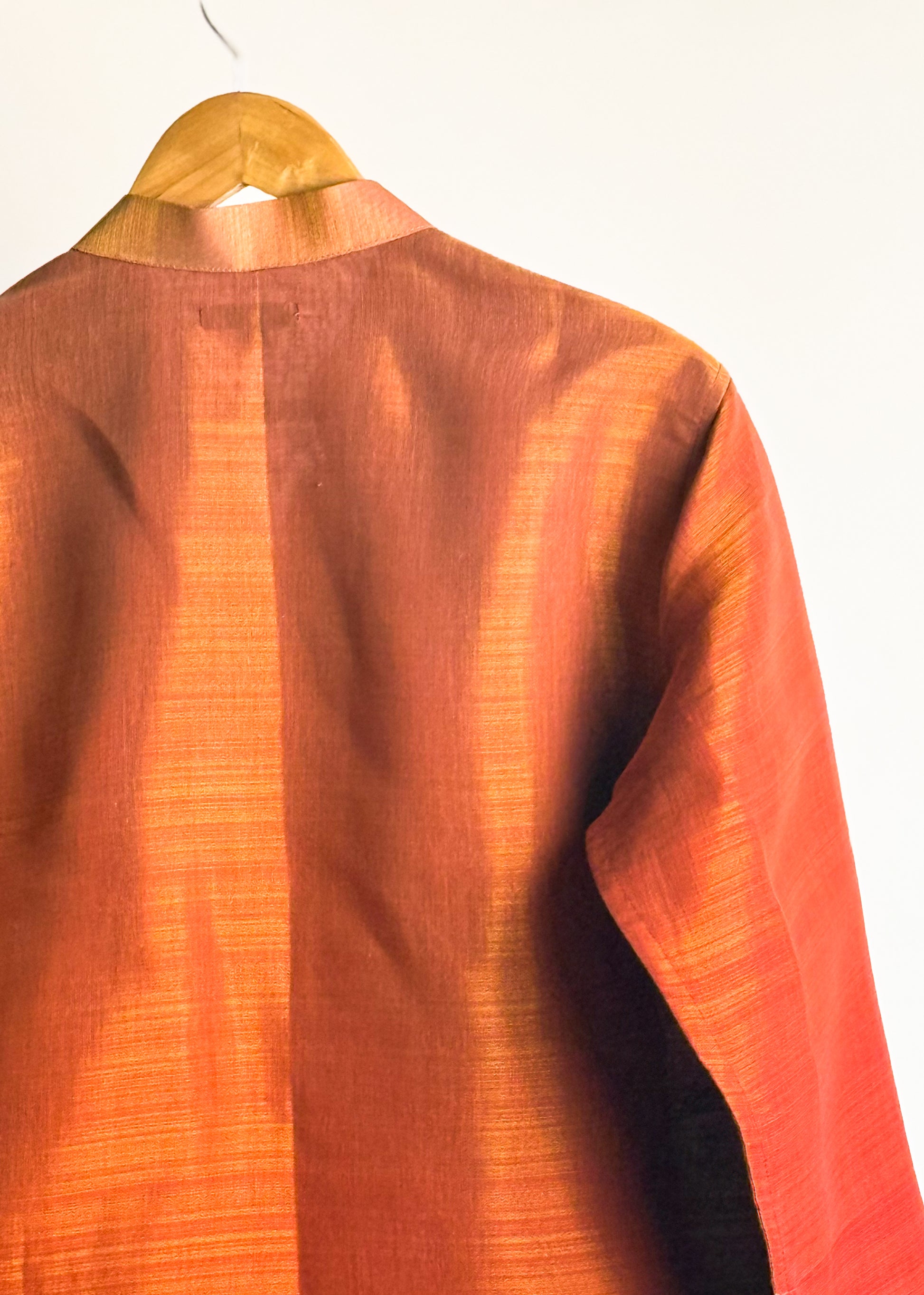 Rust shade-work men’s kurta with subtle gold zari texture and band collar