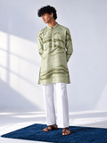 Model wearing a sage and olive hand-marbled thigh-length kurta with ivory accents, full sleeves and white trousers.