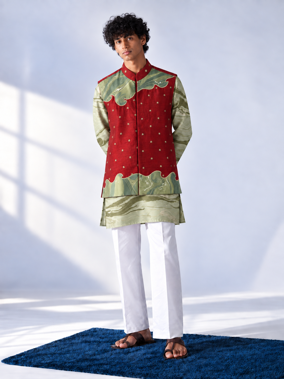  Red sleeveless bandi with gold-tone cutdana bootis and green marbled appliqué panels, worn over a sage and olive marbled kurta.