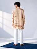  Model wearing a champagne and caramel hand-marbled thigh-length kurta with full sleeves, a band collar and white trousers.