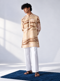  Model wearing a champagne and caramel hand-marbled thigh-length kurta with full sleeves, a band collar and white trousers.