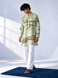 Model wearing a sage and olive hand-marbled thigh-length kurta with ivory accents, full sleeves and white trousers.