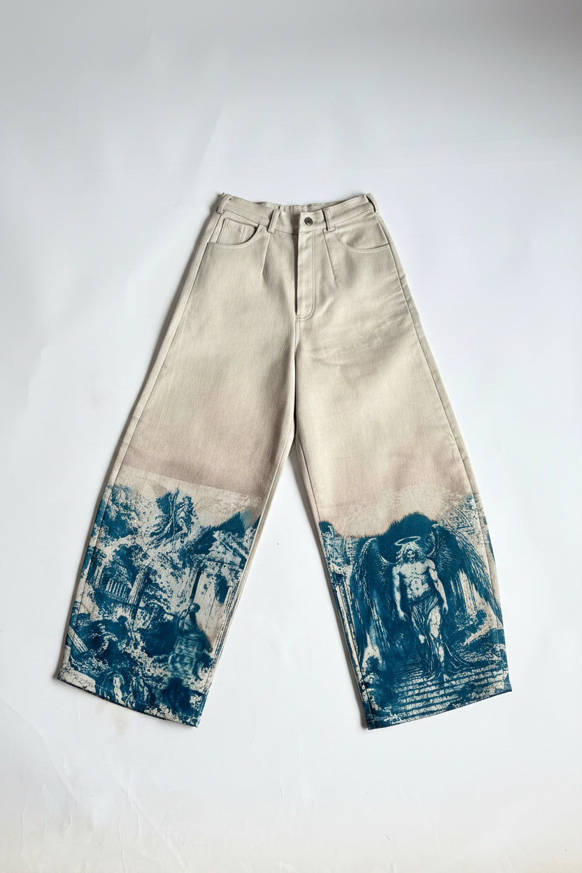 A pair of off-white barrel-leg jeans with blue vintage-style scenic prints on the lower legs, laid flat on a white background.