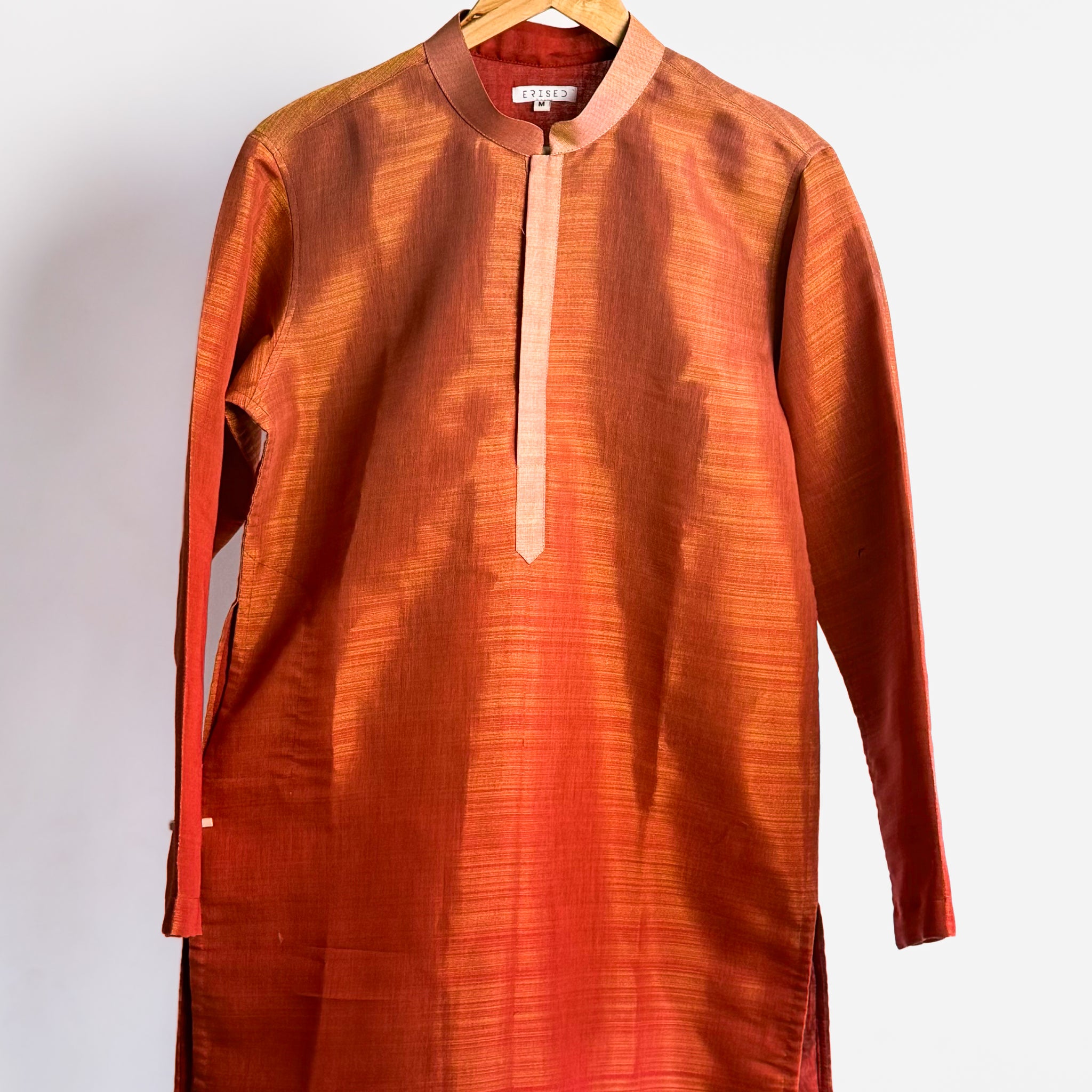 Rust shade-work men’s kurta with subtle gold zari texture and band collar