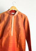 Rust shade-work men’s kurta with subtle gold zari texture and band collar
