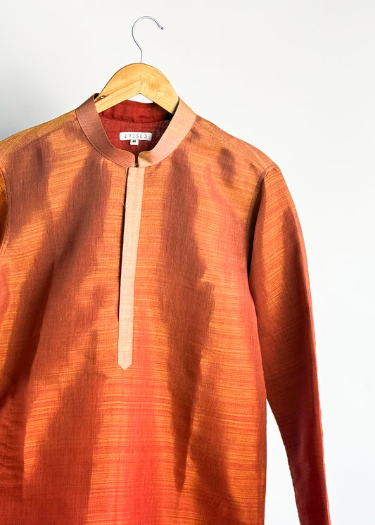 Rust shade-work men’s kurta with subtle gold zari texture and band collar