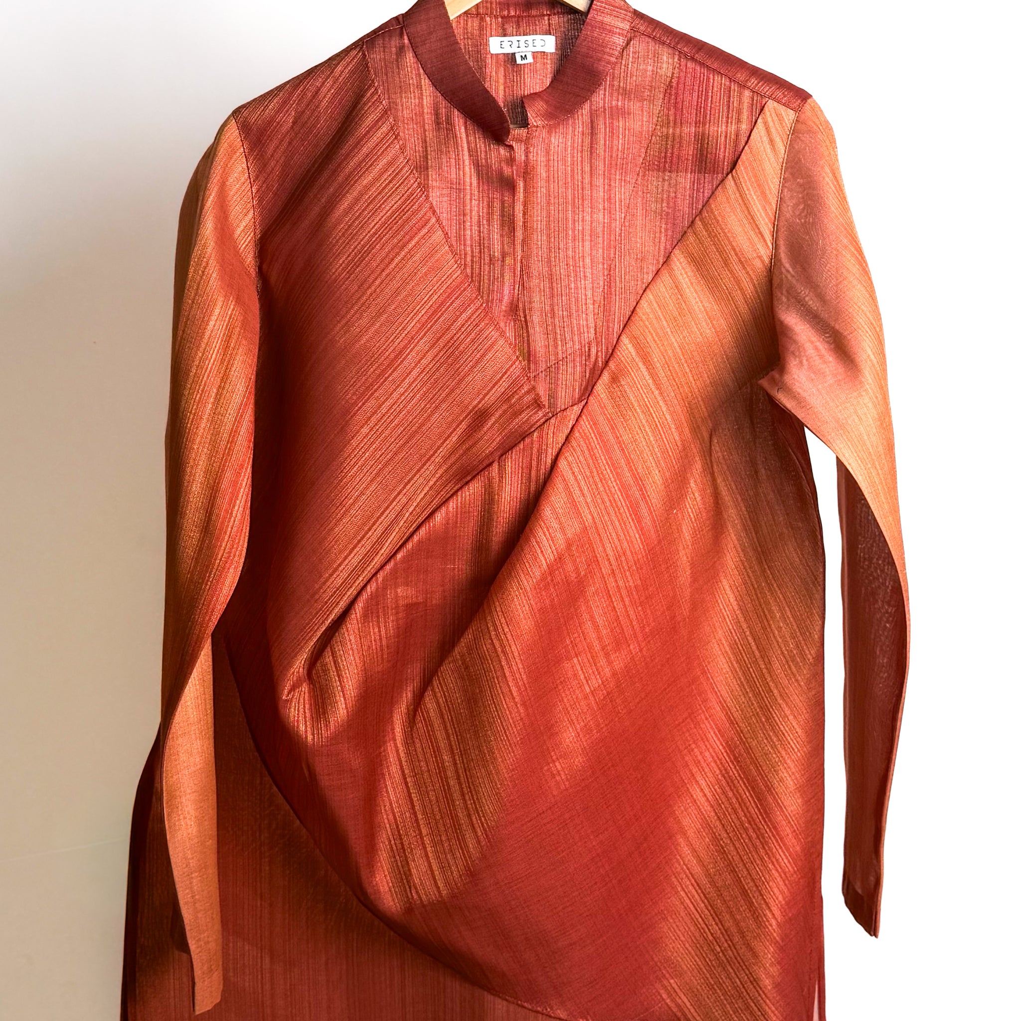 Rust drape kurta with fluid cowl, shade-work ombré and continuous gold zari lines